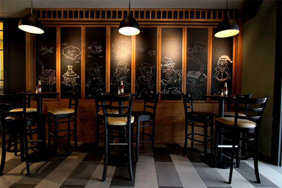 Chalkboards pull back to reveal the extensive wine collection at the Three Little Pigs.