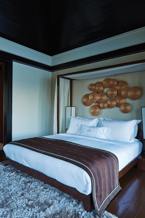 Suite bedrooms feature brass wall art and batik throws.
