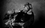 A Kazakh elder with an eagle—the seventh that he has owned in his lifetime—that he caught in the mountains when it was a chick.
