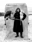 Another veteran falconer in a fox-skin coat posing with his eagle.