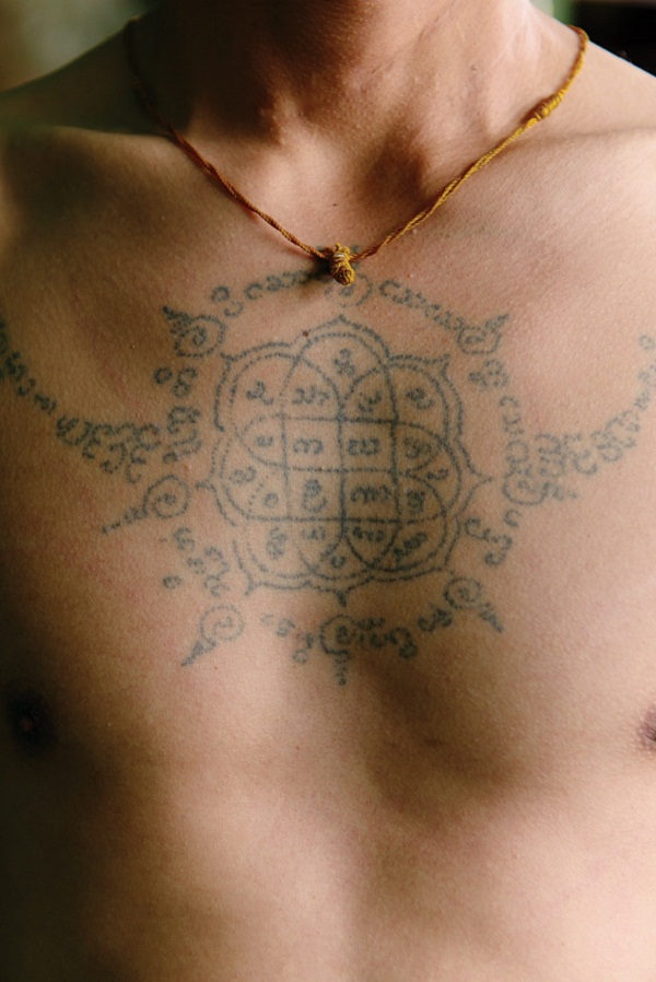A local guide shows off his Buddhist tattoo.
